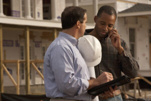 Two contractors looking over plan details
