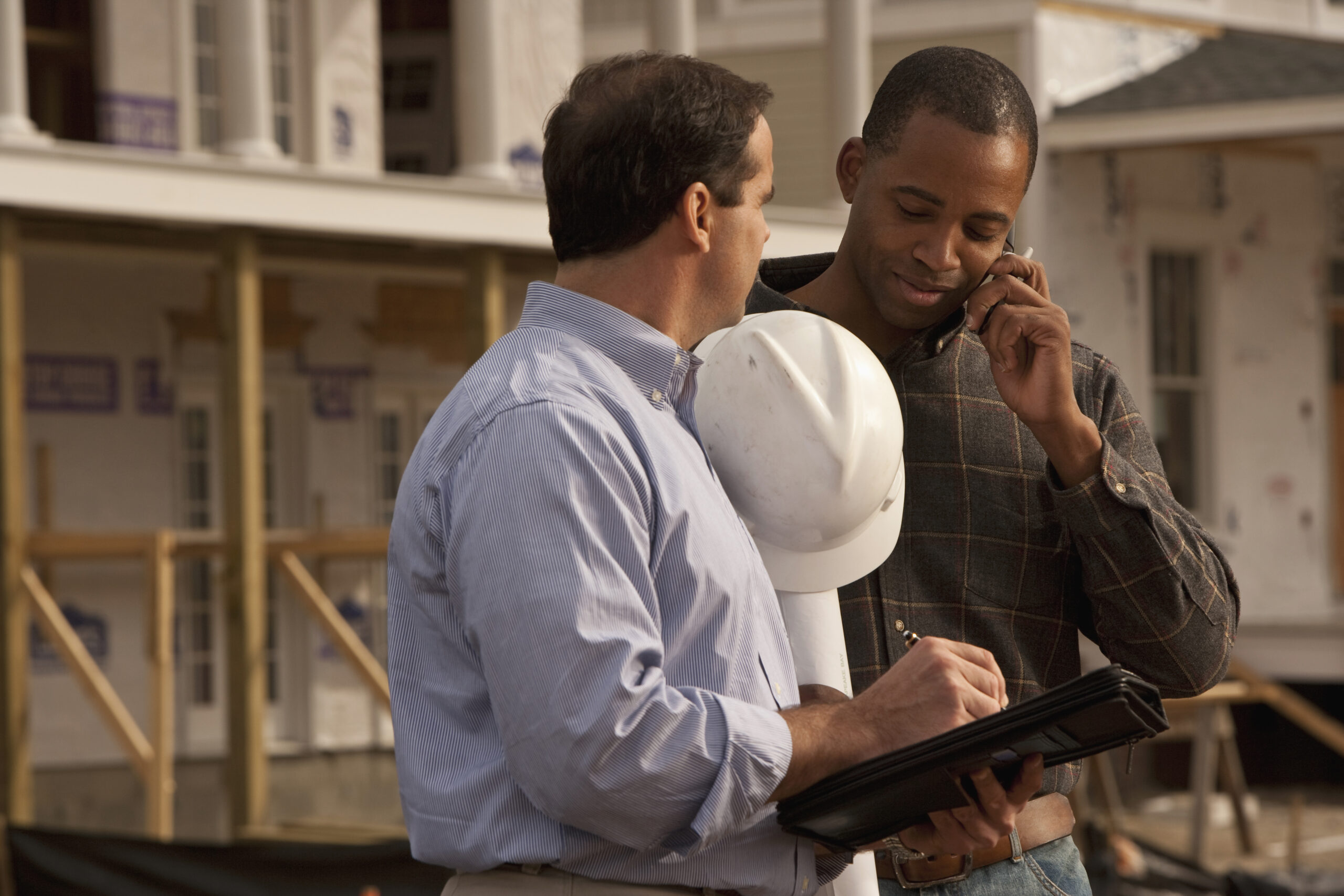 Two contractors looking over plan details
